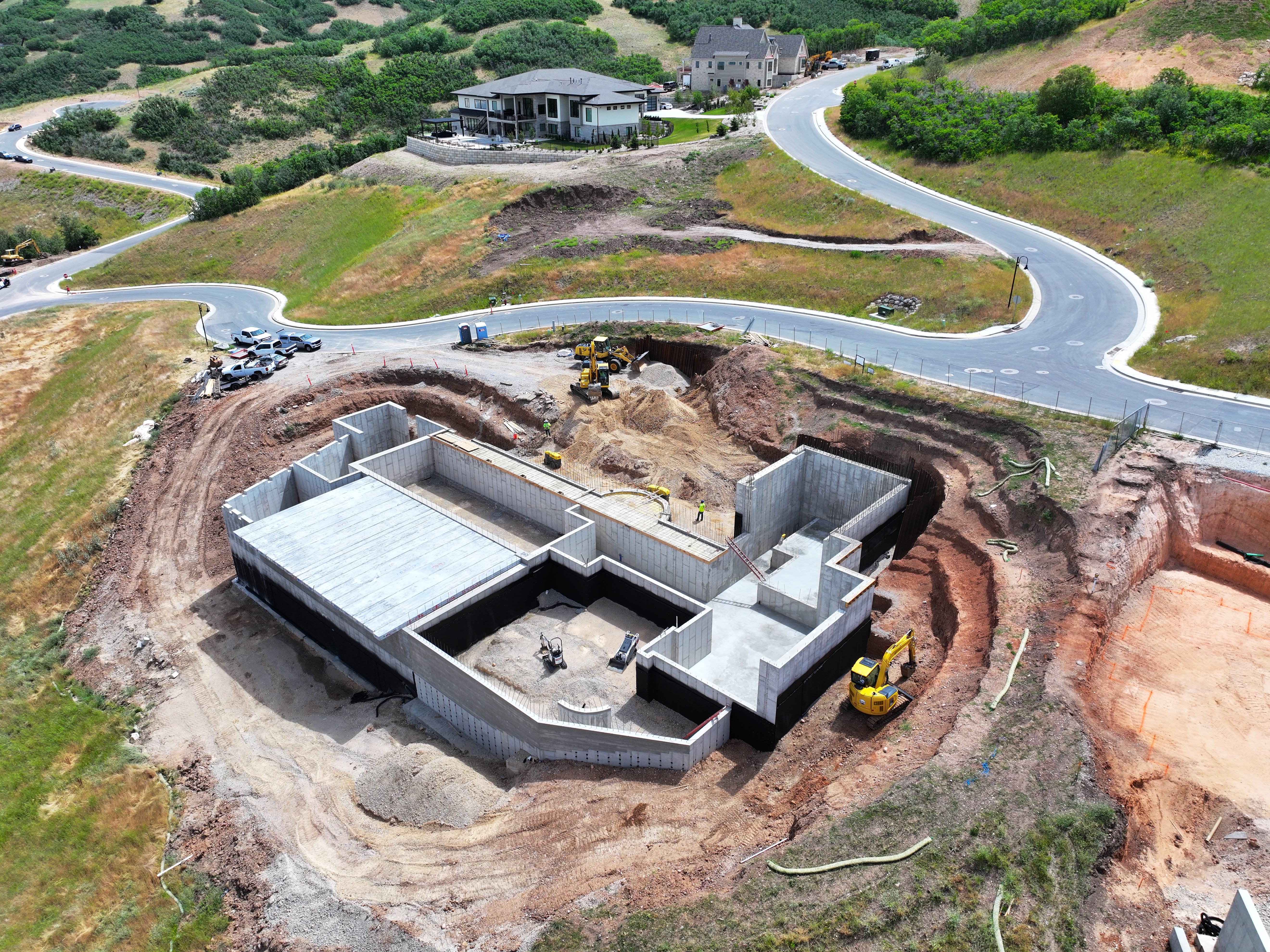Excavation and concrete crews working the same plan